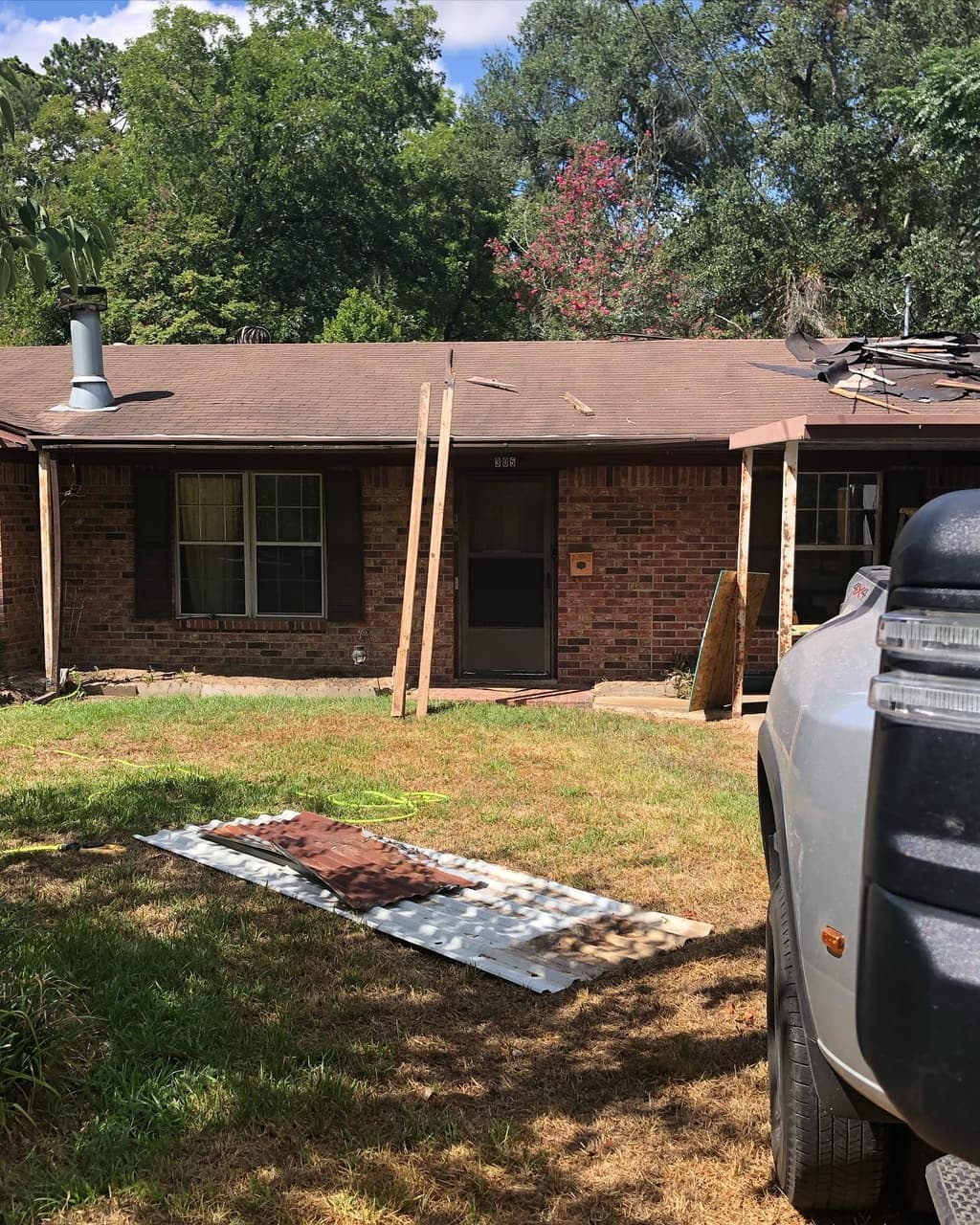 Roof repair underway on a brick home in East Texas